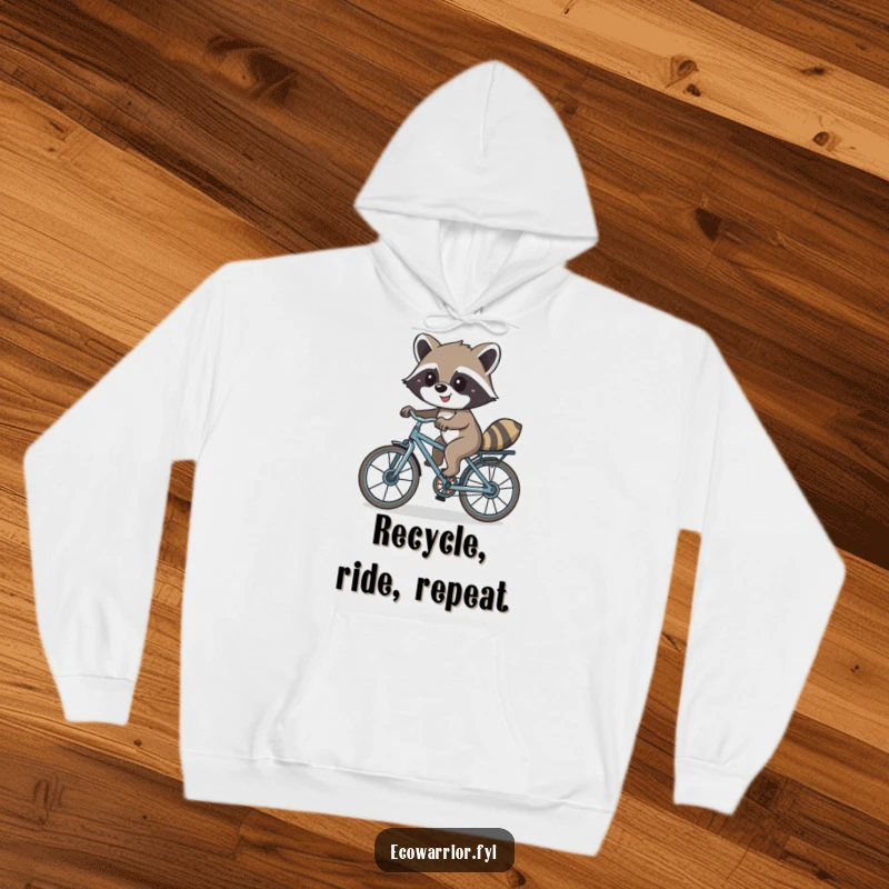 Funny hoodie featuring a smiling raccoon riding a bicycle built from recycled materials, highlighting fun and environmental awareness.