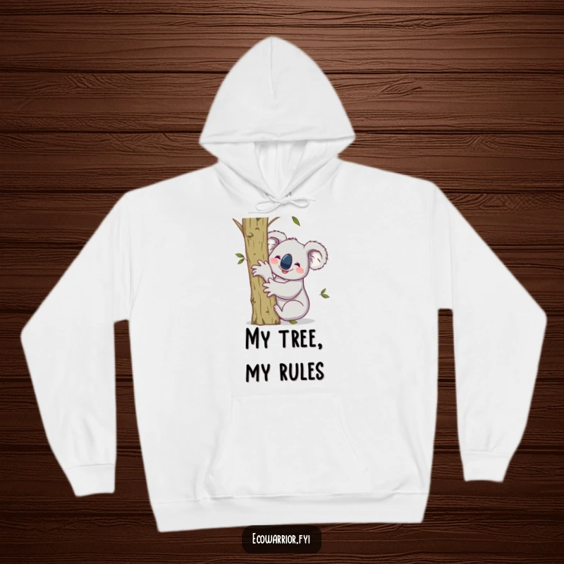 Funny hoodie featuring a smiling koala hugging a sapling, raising one arm victoriously, offering cozy eco-comfort.