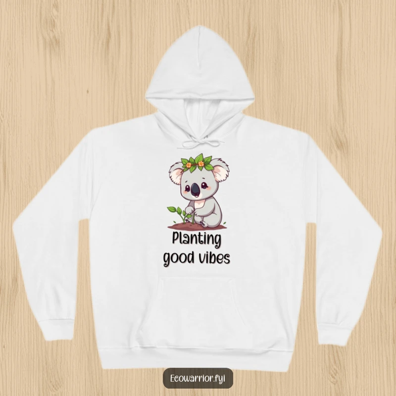 Funny Koala Hoodie: Cute koala with a leaf crown planting a tiny sapling with determination, perfect cozy nature funny gift.