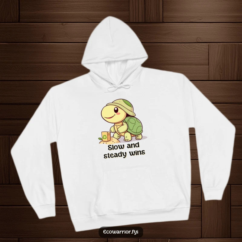 Funny hoodie featuring a smiling turtle pushing a recycled object uphill, offering warmth and a humorous symbol of persistent eco-friendly effort, a great gift.
